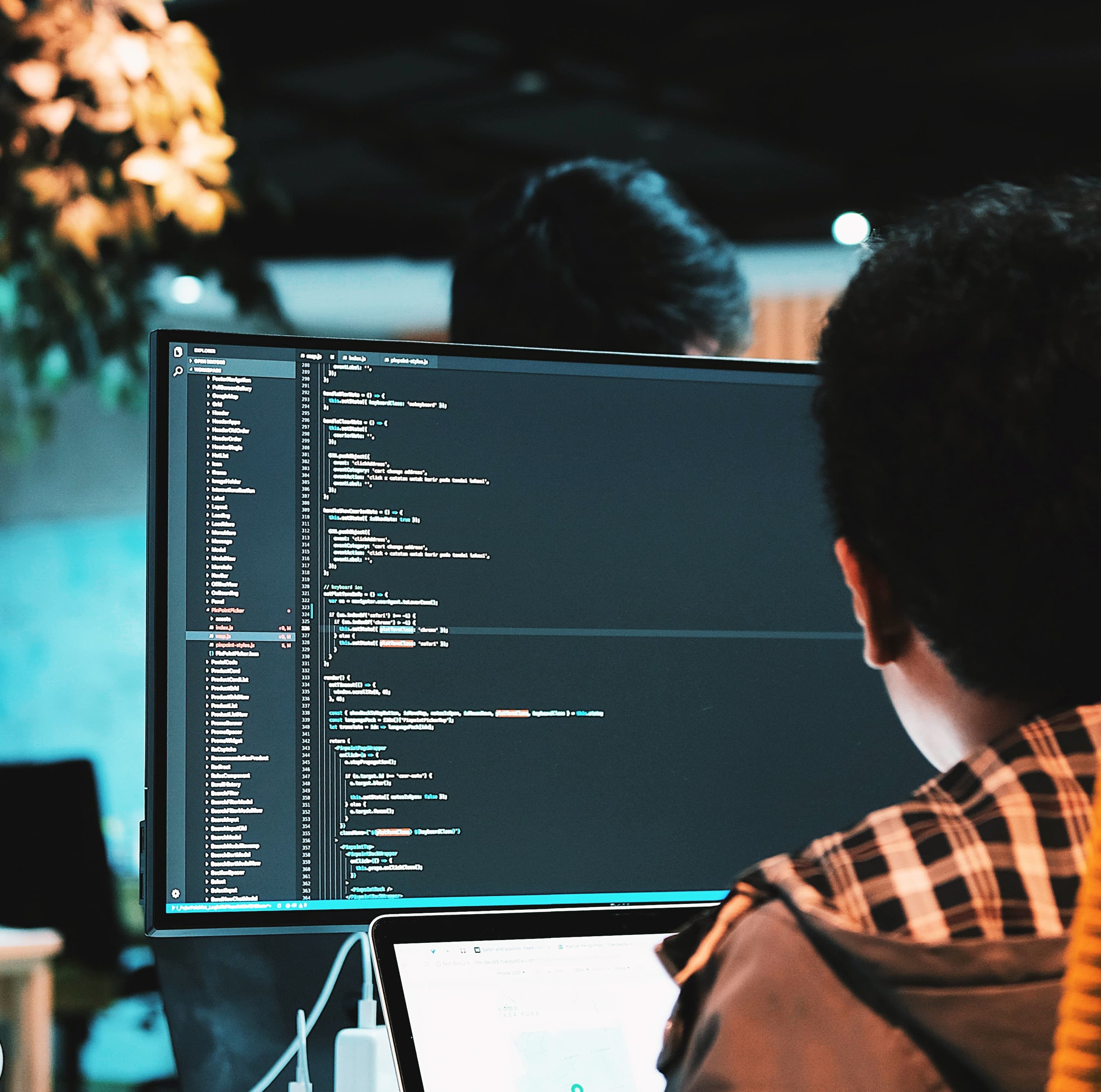 Man coding at a computer